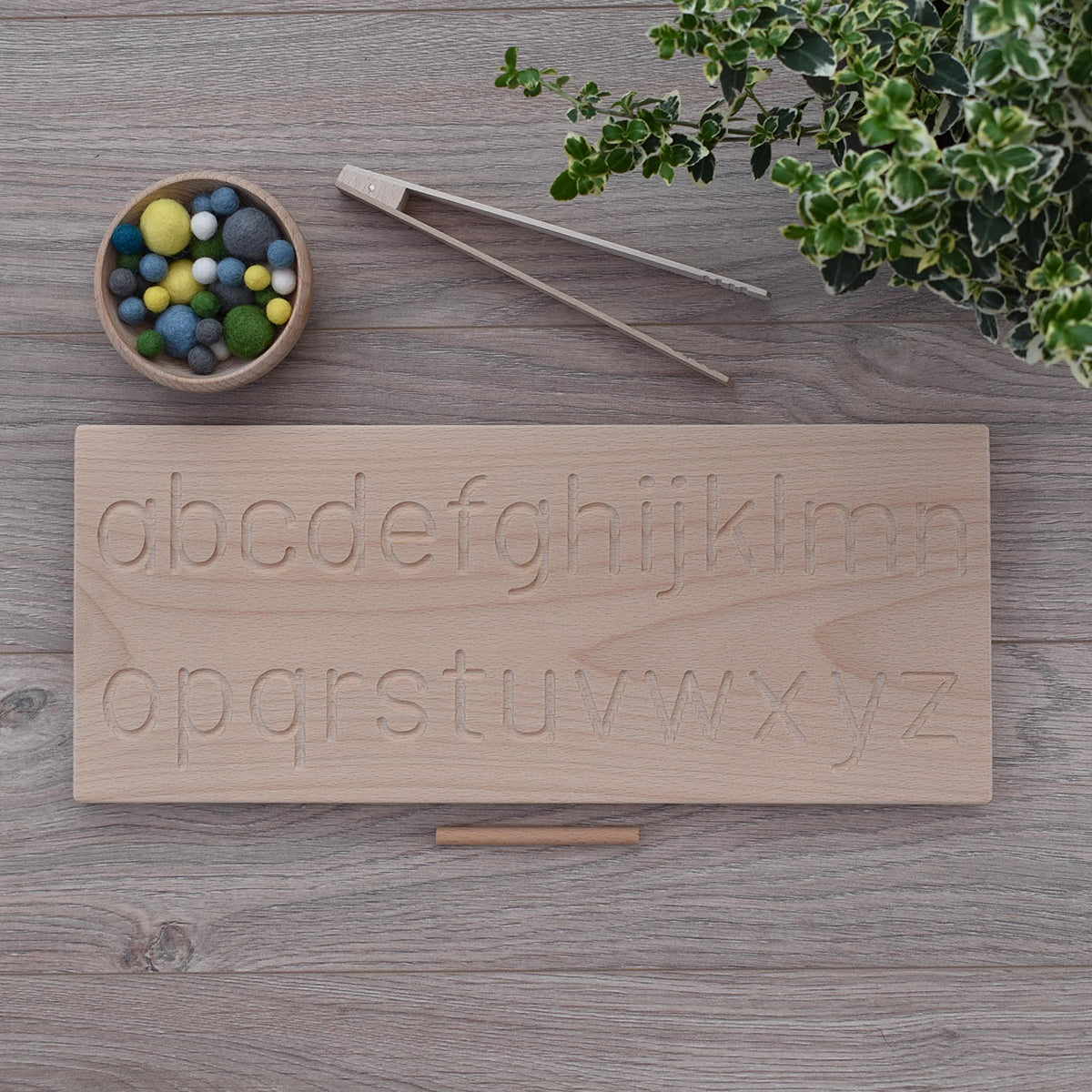 Montessori inspired wooden alphabet tracing board and felt balls