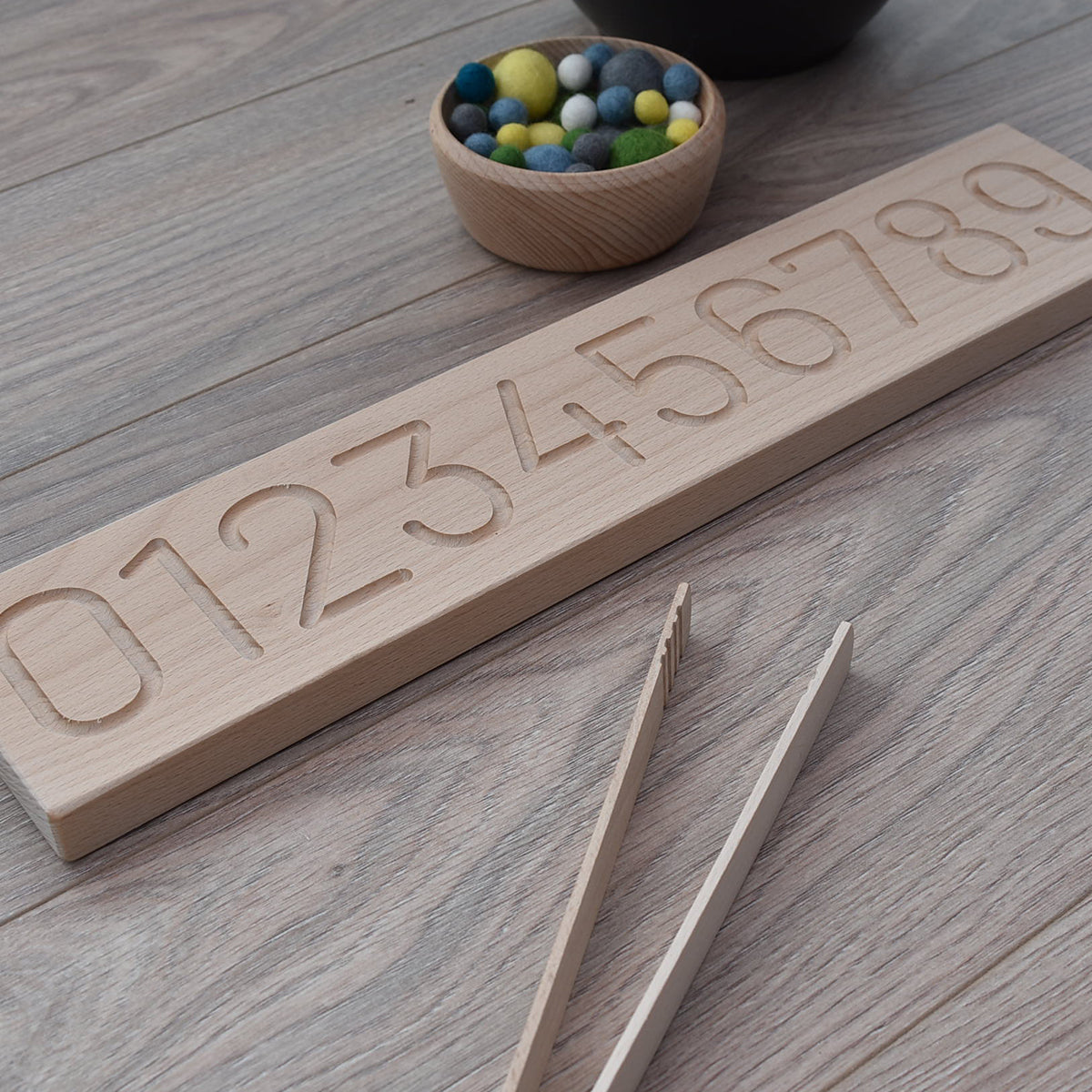 UK made wooden number board for sensory play and fine motor skills, made from sustainable Beech with chick peas felt balls and tongs