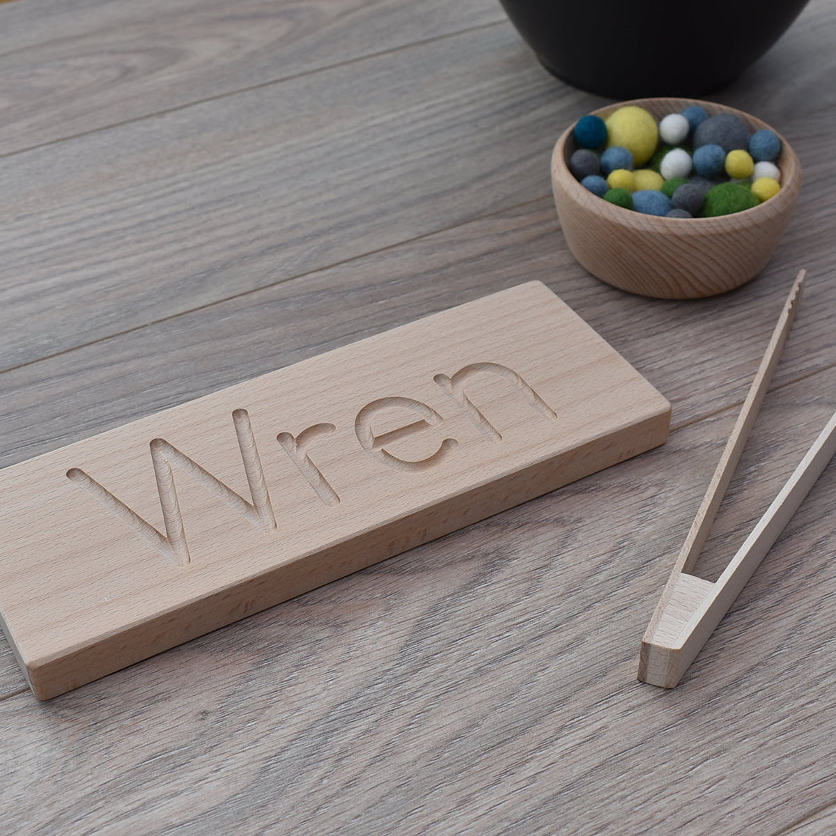 DrawMe personalised wooden name board used for learning to write and fine motor skill sensory play with felt balls